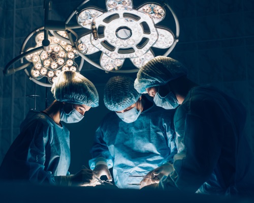 Surgeons team working with patient in surgical operating room