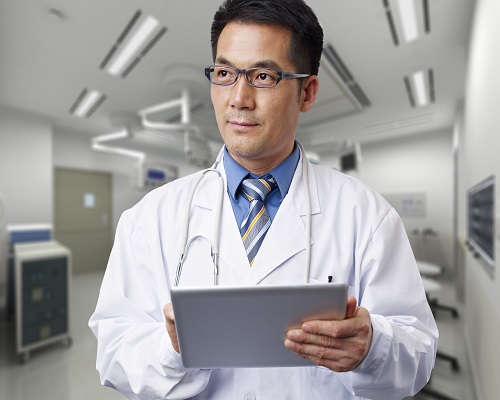 male asian doctor with tablet computer.