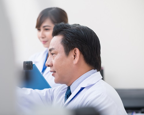 Side view of a doctor using professional equipment