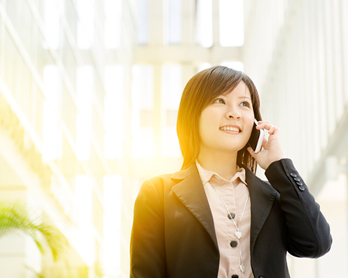 woman in a business suit talking on the phone